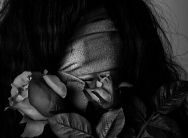 grayscale photography of woman covered by strap