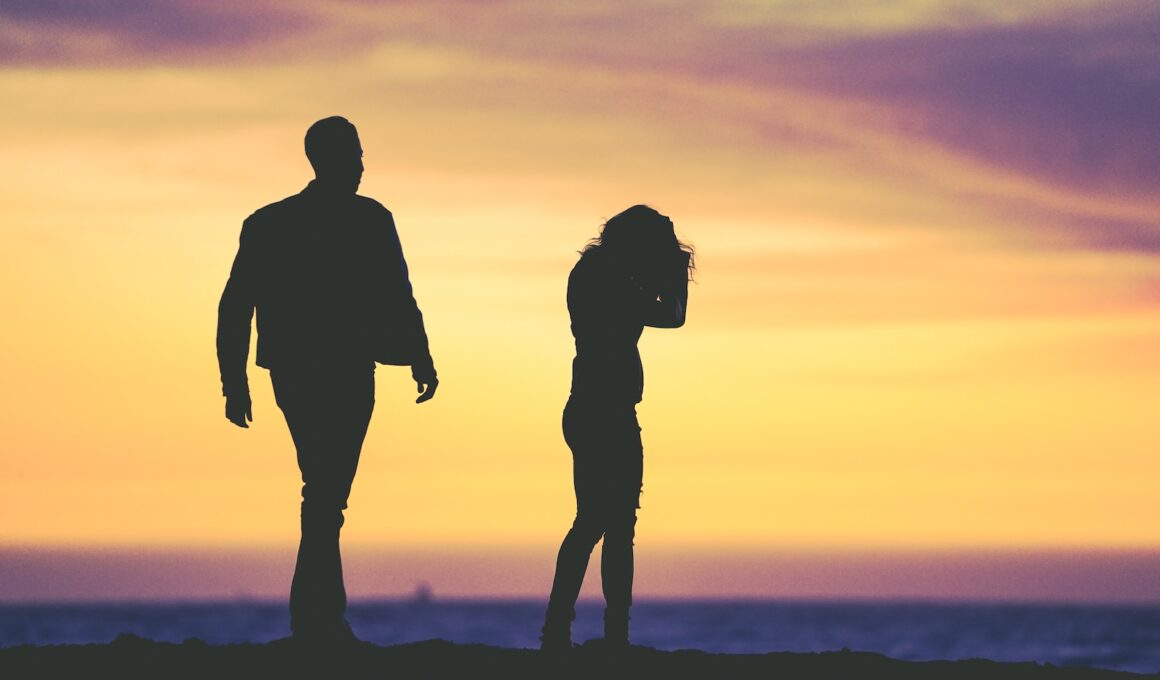 silhouette of man and woman under yellow sky